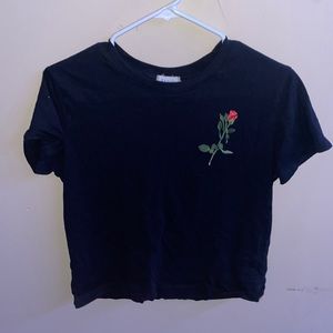 Black shirt with a rose and letters on the back